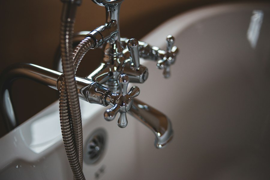 Polished chrome modern bathtub fixture and shower valve installed by Pine Rooter in Woodinville, WA